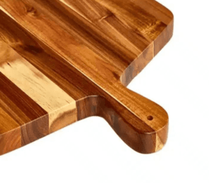 Acacia wood cutting board showing smooth handle design and deep juice groove, ideal for easy carrying and keeping countertops clean.