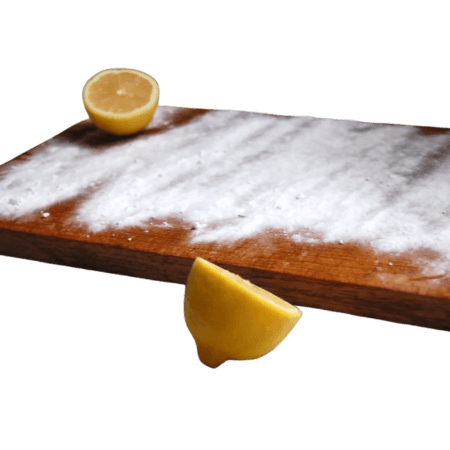 clean cutting board with baking soda, lemon